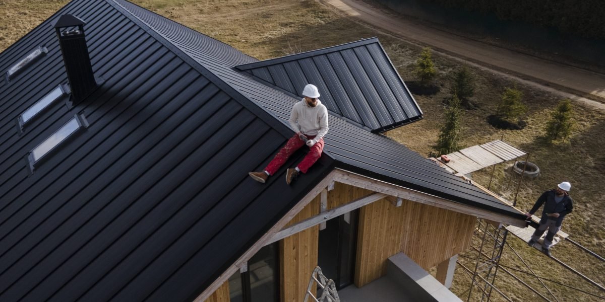 long-shot-man-with-helmet-sitting-roof